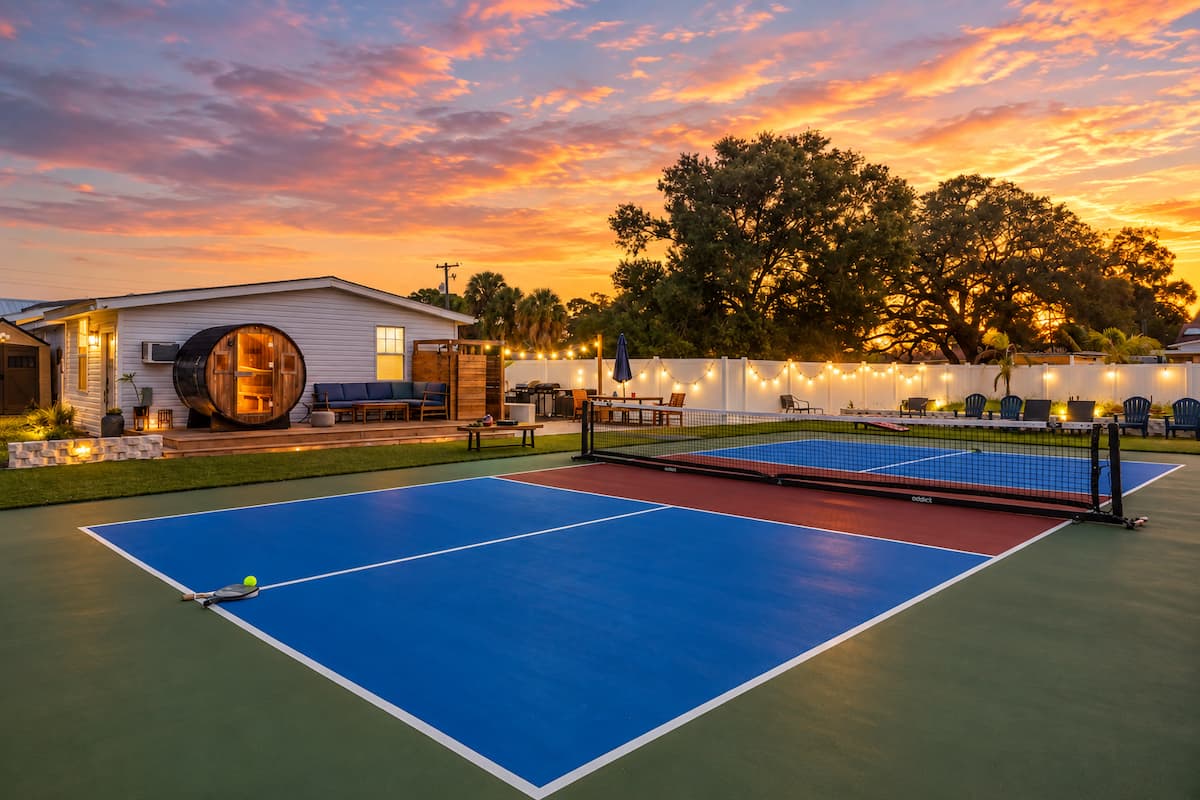 Barrel sauna and private pickleball court at sunset at Flo Haus in Tampa