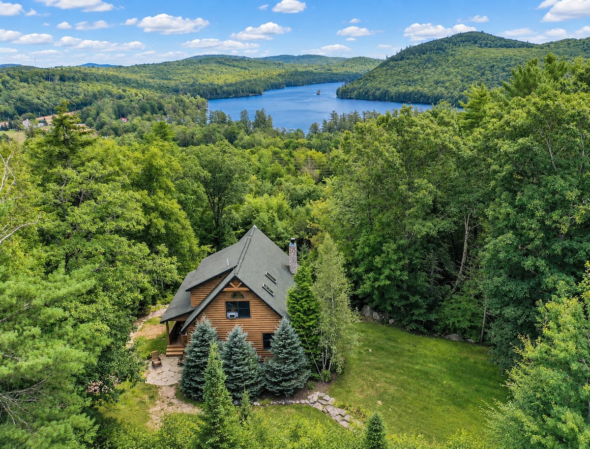 Log cabin above a lake and mountains in Bryant Pond, Maine